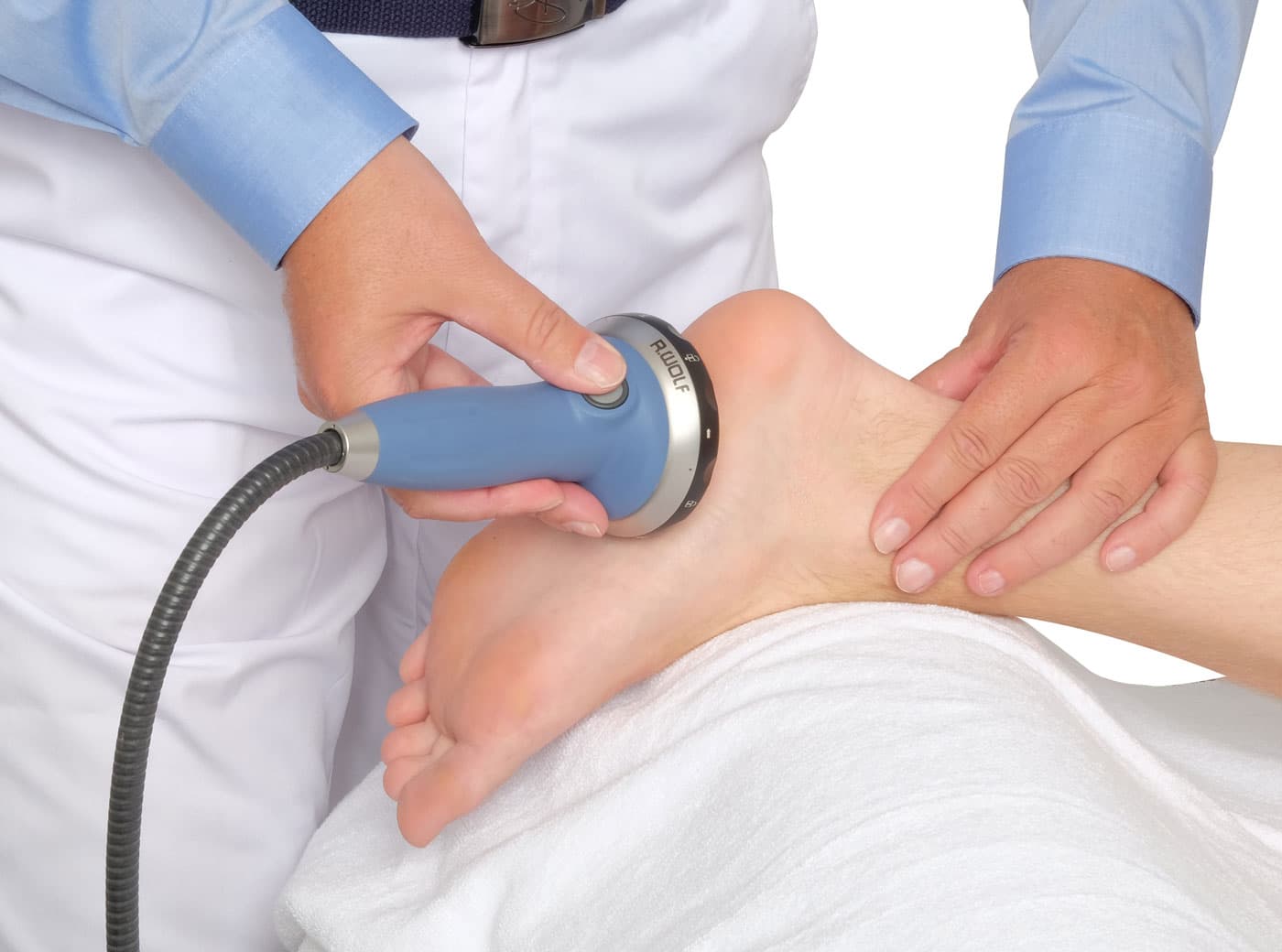 Physician performing a hands-on PiezoWave2 Focal Sound Wave treatment on a patient's heel